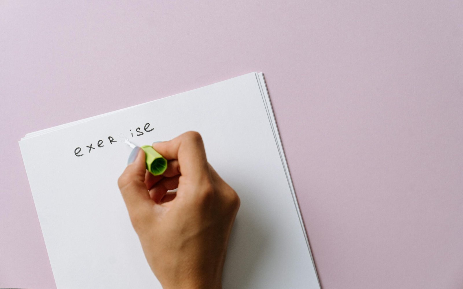 Close-up of Woman Using a White Corrector to Paint over a Letter