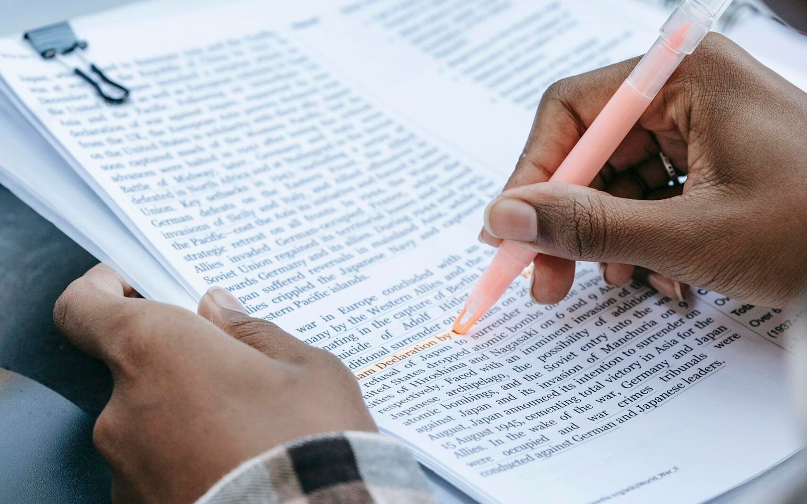 Crop faceless black person highlighting words in text